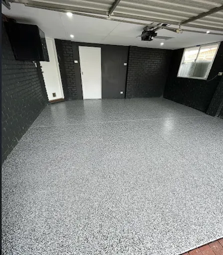 After: the same garage with a finished grey flake floor