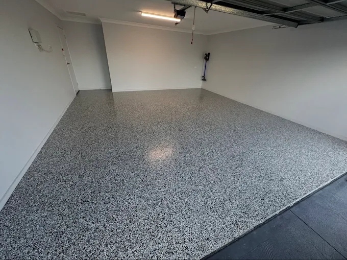 Finished double garage with a grey, black and white flake floor and gloss topcoat